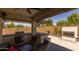 Outdoor kitchen and fireplace with a covered patio at 17178 W Buchanan St, Goodyear, AZ 85338