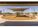 Shaded community playground with modern climbing structure, swings, and seating, a safe play environment at 17178 W Buchanan St, Goodyear, AZ 85338