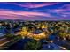 Aerial view of a neighborhood with waterfront houses, lush landscaping, and a beautiful sunset at 1724 W Blue Ridge Way, Chandler, AZ 85248