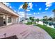 This backyard features a waterway view with a patio and lush green grass at 1724 W Blue Ridge Way, Chandler, AZ 85248