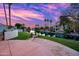 Expansive backyard featuring a waterway view, a stone patio and well-manicured landscaping at 1724 W Blue Ridge Way, Chandler, AZ 85248