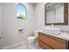Bathroom with modern sink, vanity and fixtures, and arched window at 1724 W Blue Ridge Way, Chandler, AZ 85248
