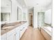 Elegant bathroom with double sinks, granite countertops, glass shower and soaking tub at 1724 W Blue Ridge Way, Chandler, AZ 85248