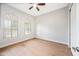 Bedroom with hardwood floors, a ceiling fan, two arched windows, and bright lighting at 1724 W Blue Ridge Way, Chandler, AZ 85248