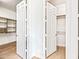 Walk-in closet featuring folding doors and convenient built-in shelving at 1724 W Blue Ridge Way, Chandler, AZ 85248