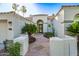 Inviting home featuring an ornate wrought iron gate, terracotta walkway, and desert landscaping at 1724 W Blue Ridge Way, Chandler, AZ 85248