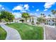 Beautiful home with manicured lawn, mature trees, and waterway views adding to its curb appeal at 1724 W Blue Ridge Way, Chandler, AZ 85248
