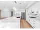 Modern kitchen boasts white cabinetry, quartz countertops, stainless steel appliances, and a spacious island at 1724 W Blue Ridge Way, Chandler, AZ 85248