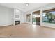 Cozy living room features a fireplace, large windows, and sliding glass doors overlooking the lake at 1724 W Blue Ridge Way, Chandler, AZ 85248