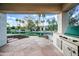 Enjoy outdoor living with this patio featuring a built-in grill and scenic waterfront views at 1724 W Blue Ridge Way, Chandler, AZ 85248
