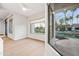 Bright sitting area with large windows providing serene lake views and access to the outdoor space at 1724 W Blue Ridge Way, Chandler, AZ 85248