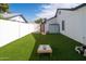 Lush backyard with artificial turf and outdoor games setup, ideal for entertainment and recreation at 1800 W Shawnee Dr, Chandler, AZ 85224