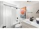 Modern bathroom featuring a shower-tub combo, neutral tiling, and clean vanity at 1800 W Shawnee Dr, Chandler, AZ 85224