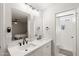 Bright bathroom features dual sinks, modern fixtures, large mirrors, and walk-in shower at 1800 W Shawnee Dr, Chandler, AZ 85224