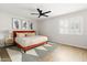 A spacious bedroom with hardwood floors, contemporary decor, and a large king size bed frame at 1800 W Shawnee Dr, Chandler, AZ 85224