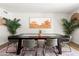 Elegant dining room with a rustic wooden table, designer rug, and modern lighting at 1800 W Shawnee Dr, Chandler, AZ 85224