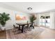 Open dining area with a large table, stylish rug, and sliding glass doors to the pool at 1800 W Shawnee Dr, Chandler, AZ 85224