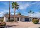 Charming single-story home featuring a well-maintained yard with palm trees and a two-car garage at 1800 W Shawnee Dr, Chandler, AZ 85224