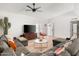 Bright living room with hardwood floors, comfortable sectional sofa, and a modern ceiling fan at 1800 W Shawnee Dr, Chandler, AZ 85224