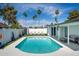Beautiful backyard pool with lounge chairs, palm trees, and well-maintained landscaping at 1800 W Shawnee Dr, Chandler, AZ 85224