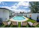 Inviting backyard pool featuring lounge chairs, artificial turf, and privacy fence, perfect for relaxing and entertaining at 1800 W Shawnee Dr, Chandler, AZ 85224
