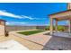 Wide angle view of the backyard that features landscaping with gravel and a patch of faux grass at 18514 W Williams Rd, Surprise, AZ 85387