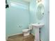 Powder room featuring a pedestal sink, toilet, and window at 18514 W Williams Rd, Surprise, AZ 85387