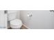 Standard white toilet shown against a white wall with a chrome toilet paper holder at 18514 W Williams Rd, Surprise, AZ 85387