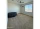 Bedroom with ceiling fan, large window, and a comfortable bean bag at 18514 W Williams Rd, Surprise, AZ 85387