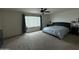 Bedroom featuring ceiling fan, window with dark gray curtains, ceiling light and dark furniture at 18514 W Williams Rd, Surprise, AZ 85387