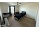 Bedroom features ceiling fan, window with dark gray curtains, ceiling light and dark furniture at 18514 W Williams Rd, Surprise, AZ 85387