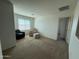 Bright bonus room featuring neutral carpet, cozy seating, and a window for natural light at 18514 W Williams Rd, Surprise, AZ 85387