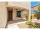 Inviting covered entryway with a dark wood door and stone accents at 18514 W Williams Rd, Surprise, AZ 85387