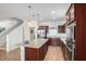 Kitchen with a large island, stainless steel appliances, and wood-look flooring at 18514 W Williams Rd, Surprise, AZ 85387
