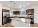 Kitchen with a large island, stainless steel appliances, and light granite counters at 18514 W Williams Rd, Surprise, AZ 85387