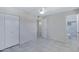 Bedroom with a ceiling fan, large closet, tiled floors, and bathroom access at 2030 E Alder Cir, Mesa, AZ 85204