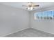 Bedroom with a ceiling fan, tiled floors, and a bright window at 2030 E Alder Cir, Mesa, AZ 85204