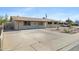 Exterior view of a single-story home featuring a spacious driveway at 2030 E Alder Cir, Mesa, AZ 85204