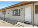 View of front porch with a white door, window and neutral siding at 2030 E Alder Cir, Mesa, AZ 85204