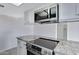 Updated kitchen featuring granite countertops, new appliances, and white cabinets at 2030 E Alder Cir, Mesa, AZ 85204