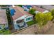 Stunning aerial view of a home featuring a putting green, patio with fire pit, and solar panels for energy efficiency at 20784 W Minnezona Ave, Buckeye, AZ 85396