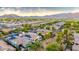 Scenic aerial view of a well-planned community with mountain backdrop and mature trees at 20784 W Minnezona Ave, Buckeye, AZ 85396
