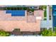 A captivating aerial shot showcases the rooftop solar panels and quaint patio at 20784 W Minnezona Ave, Buckeye, AZ 85396