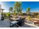 Well-manicured backyard with outdoor seating area around a fire pit, ideal for outdoor entertaining at 20784 W Minnezona Ave, Buckeye, AZ 85396