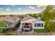 A charming backyard with a covered patio, fire pit, and mini golf course at 20784 W Minnezona Ave, Buckeye, AZ 85396