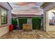 Back patio featuring a stone fountain, metal trellises, and lush greenery at 20784 W Minnezona Ave, Buckeye, AZ 85396