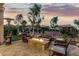 Relaxing backyard space featuring a stone fire pit, comfortable seating, mature landscaping, and a tranquil ambiance at 20784 W Minnezona Ave, Buckeye, AZ 85396