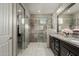 Modern bathroom with glass-enclosed shower, granite counters, and stylish vanity at 20784 W Minnezona Ave, Buckeye, AZ 85396
