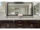 Bathroom features double sinks, granite countertops, dark cabinets, and a large mirror at 20784 W Minnezona Ave, Buckeye, AZ 85396