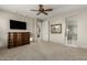 Bedroom features a ceiling fan, hard flooring, and an en-suite bathroom at 20784 W Minnezona Ave, Buckeye, AZ 85396